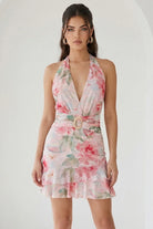 Watercolor floral ruffle halter mini dress in peach by RARA Boutique, featuring soft fabric and feminine ruffle details.