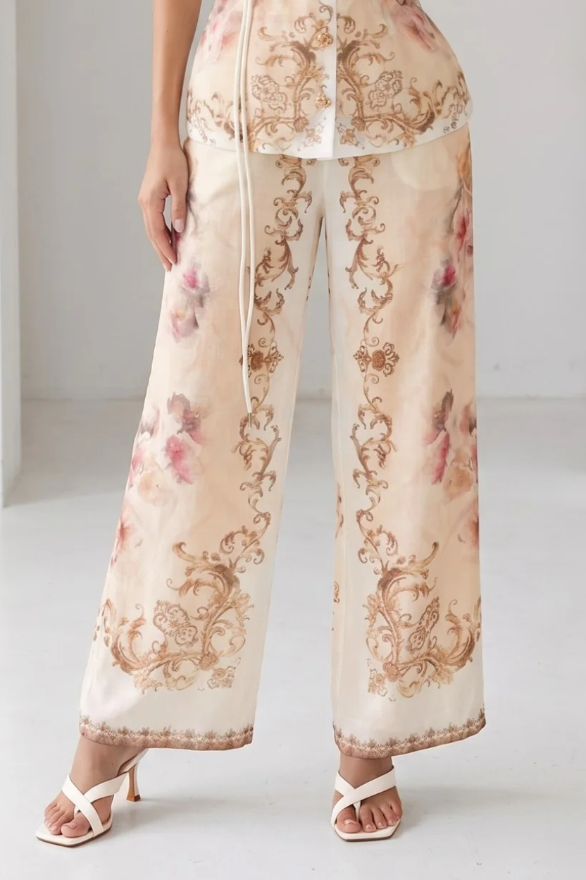 Peach watercolor floral baroque border wide-leg pants from RARA Boutique, with flowing fabric and intricate floral designs.