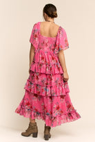Floral tiered ruffle maxi dress with flutter sleeves from RARA Boutique, featuring a flowy silhouette and vibrant floral pattern.