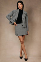 Houndstooth mini skort by Sunday Edition by LE LIS featuring a stylish checkered pattern and a fitted silhouette.