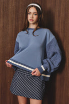 Le Lis sweatshirt with knit sweater sleeves, featuring a cozy, stylish design and contrasting fabric textures.