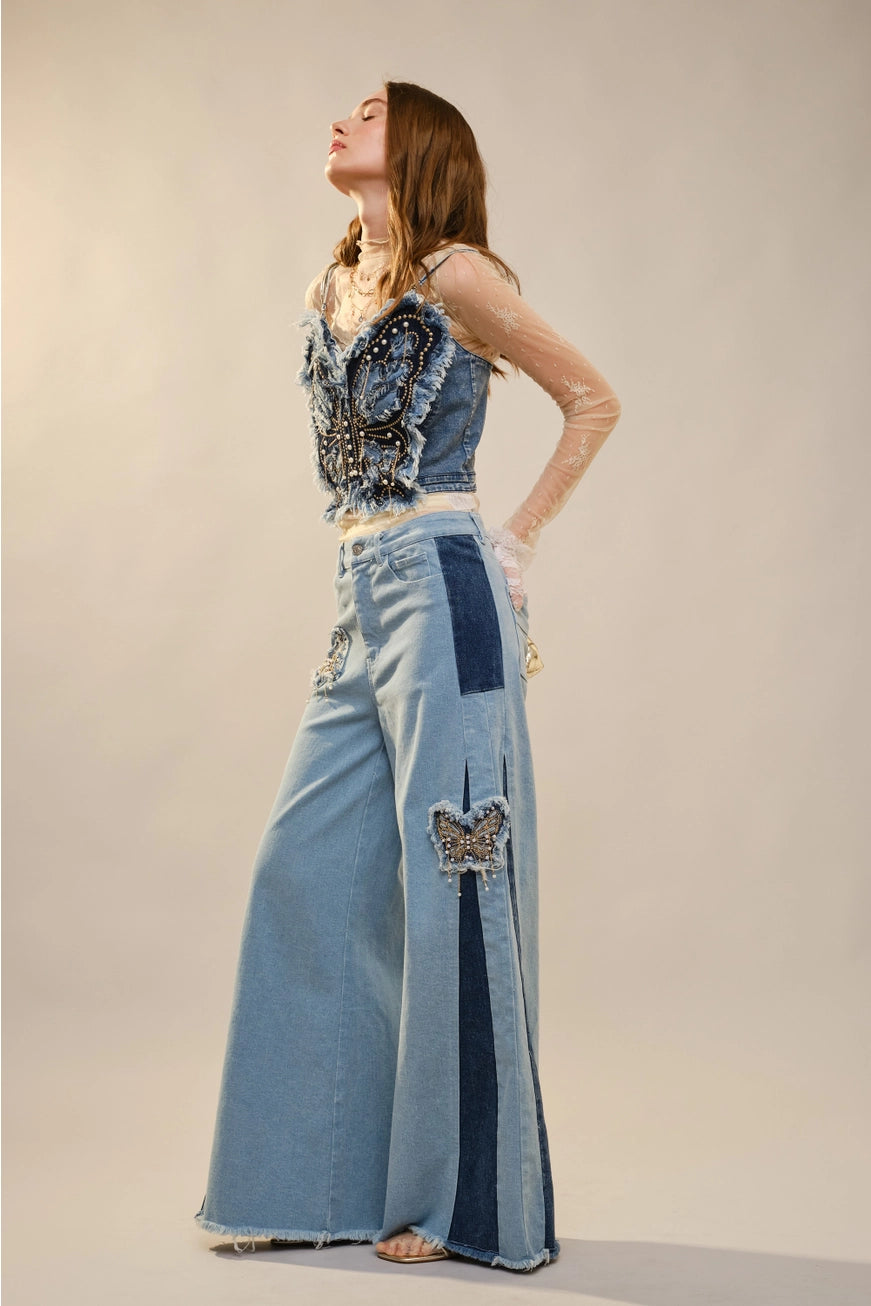 Blue denim corset top with butterfly embellishments, stylish blouse by RARA Boutique, featuring detailed butterfly decorations.