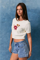 USA Dog graphic short-sleeve cropped sweater top by Le Lis, featuring a stylish dog design on a cozy sweater for women.