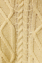 LE LIS oversized cropped cable knit sweater featuring chunky knit cable pattern and a relaxed, cropped fit in soft fabric.