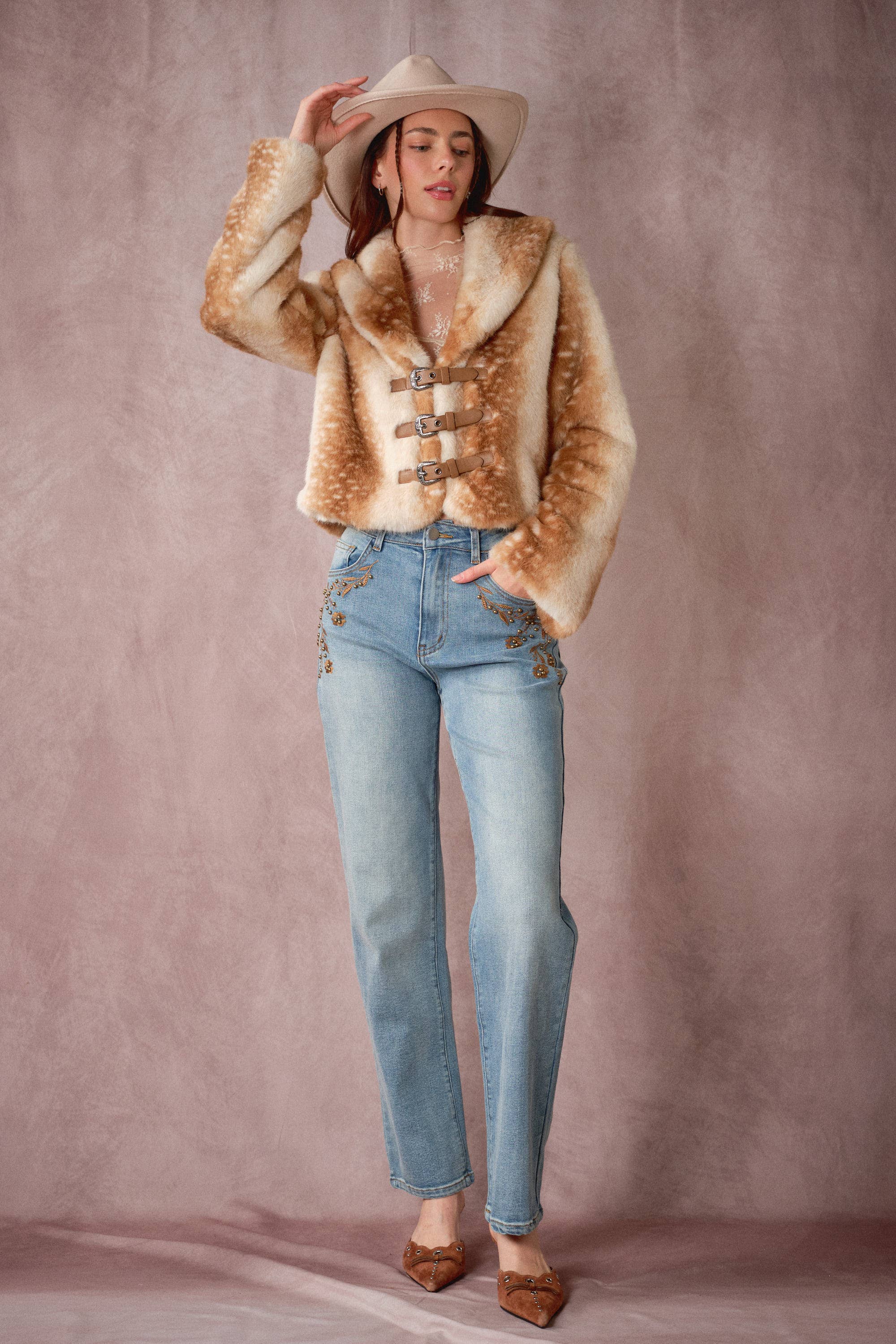 Blue B 25004J buckled faux fur jacket with deer print and buckle details, showcasing its stylish design and soft texture.
