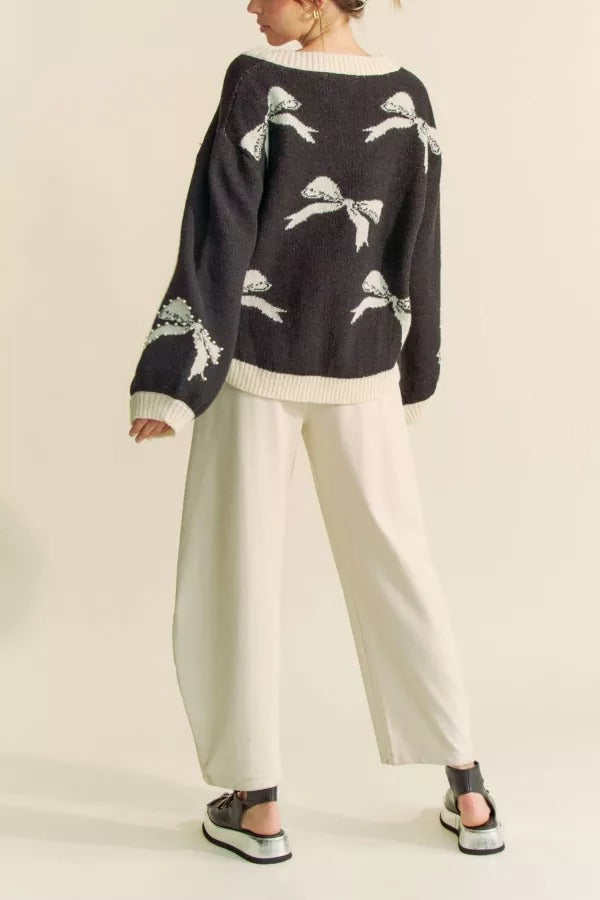 RARA Boutique pearl studded bow balloon sleeve V-neck sweater, stylish knit with decorative pearl details and a relaxed fit.