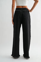 RARA Boutique studded ultra wide-leg washed jeans with distressed details and metal stud accents, front view showing fit and style.