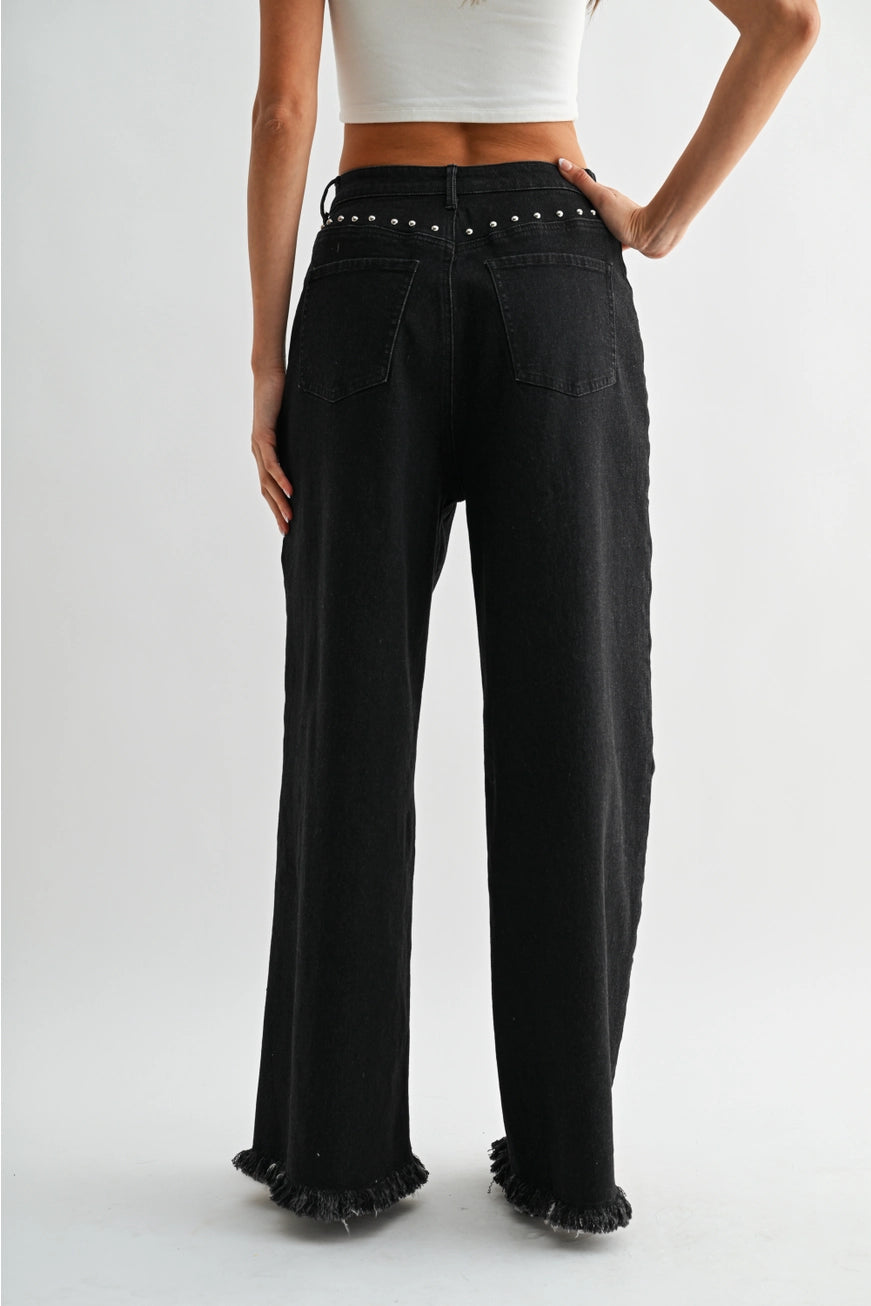 RARA Boutique studded ultra wide-leg washed jeans with distressed details and metal stud accents, front view showing fit and style.