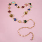 Gemstone cabochon station chain belt by Collections by Fame Accessories, featuring colorful polished stones along a sleek metal chain.