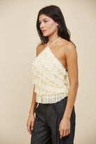 RARA Boutique tiered ruffle halter neck tank top featuring layered fabric and a stylish halter neckline.