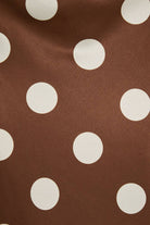 Mid-wisted polka dot bias skirt by LE LIS, featuring a flowing fabric with a classic black and white dotted pattern.