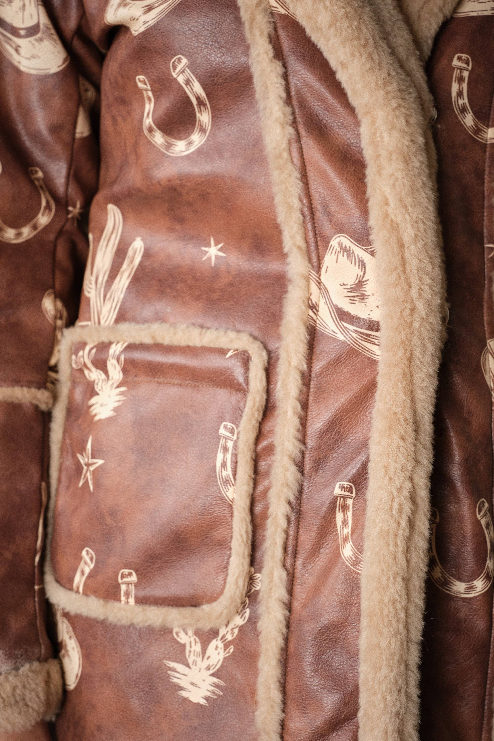 Blue B Western printed faux leather coat with intricate Western design and detailed patterns on a stylish jacket.