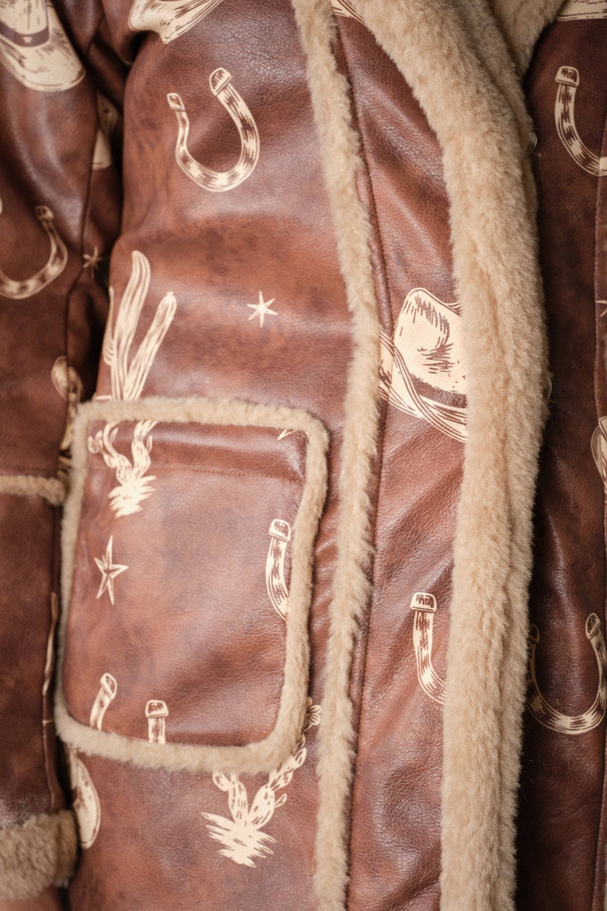 Blue B Western printed faux leather coat with intricate Western design and detailed patterns on a stylish jacket.