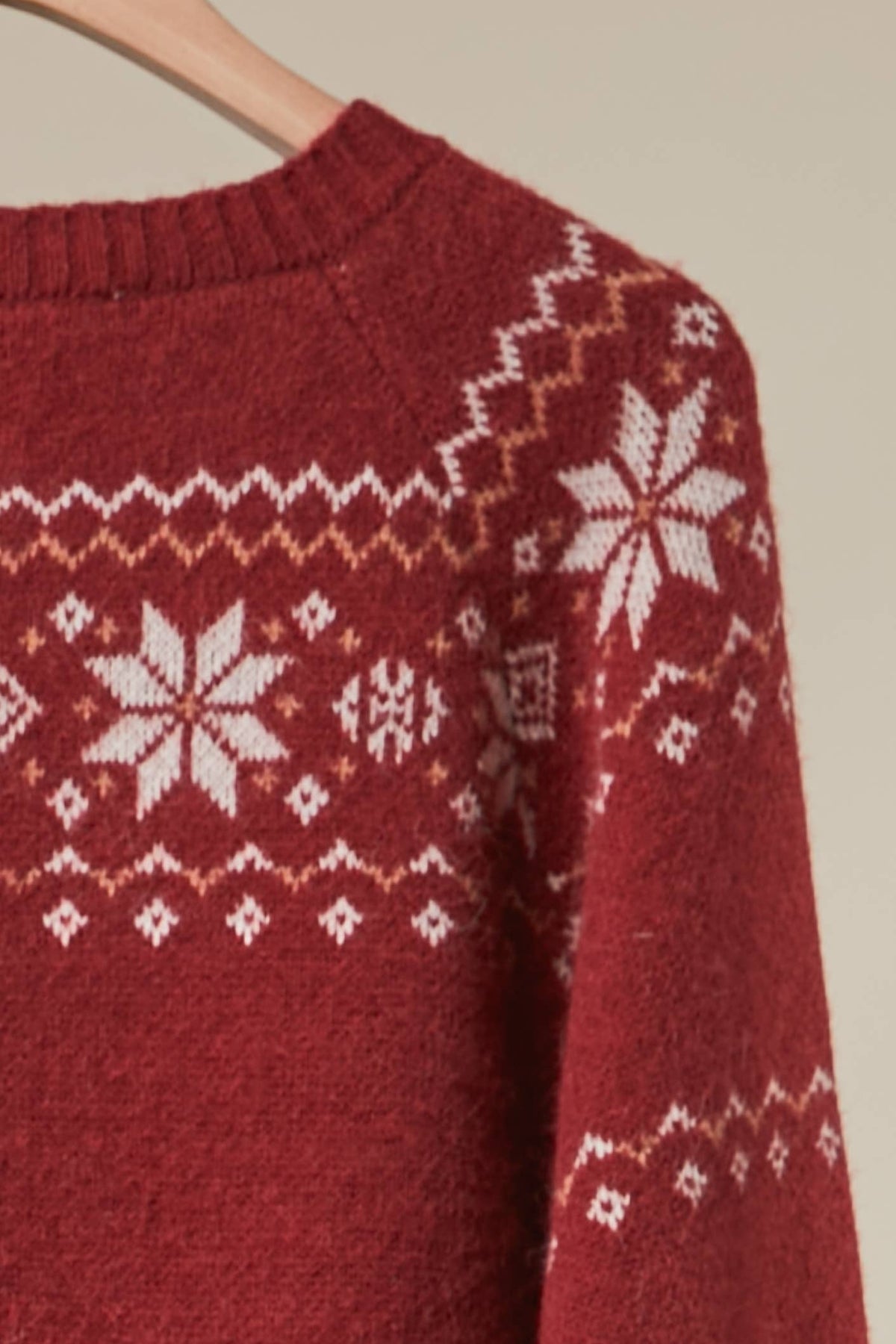 Reindeer Fair Isle knit cardigan by Mello featuring festive reindeer and snowflake patterns in cozy wool blend.