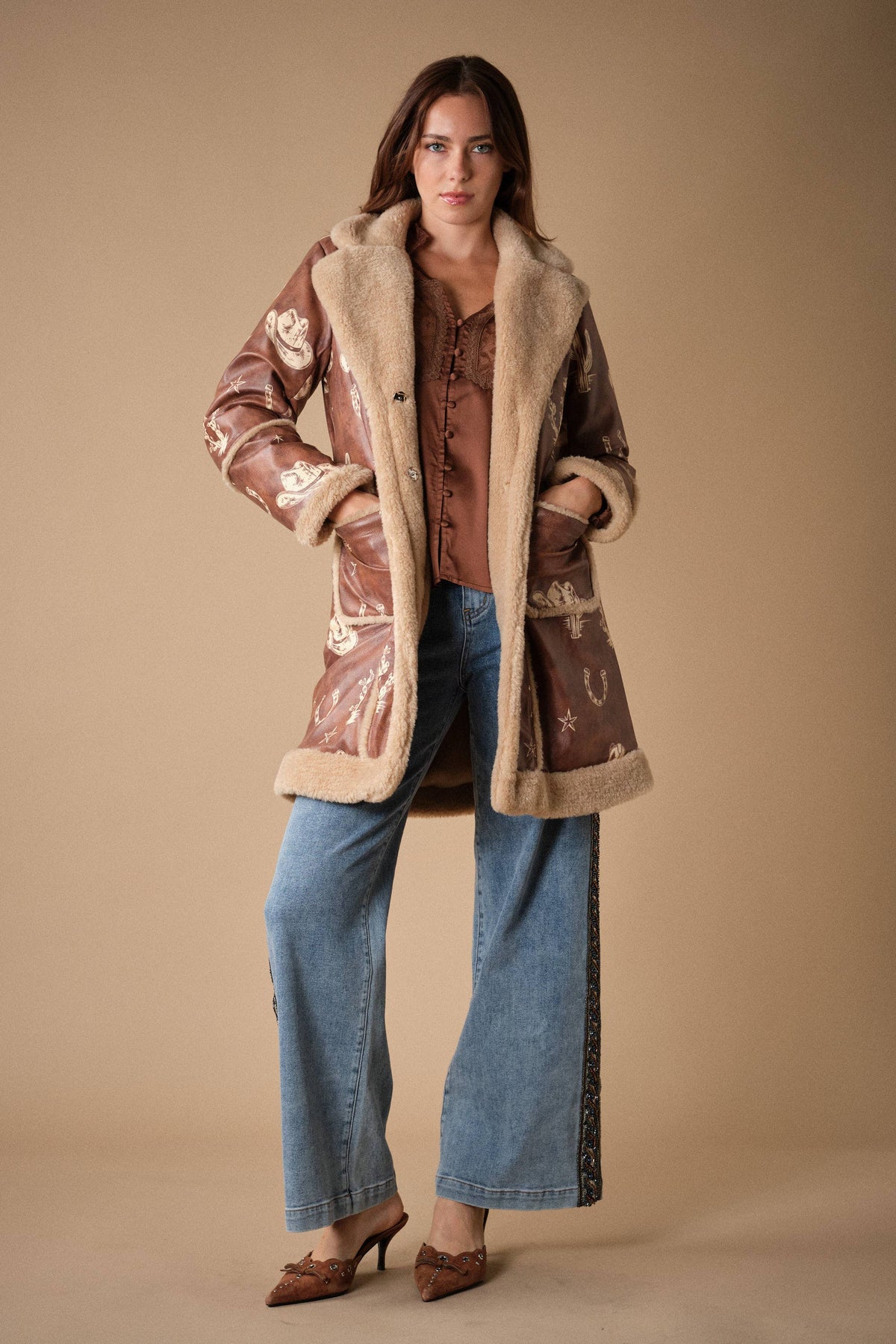 Blue B 25074J Western printed faux leather coat with detailed Western-inspired print and classic collar, shown on a hanger.