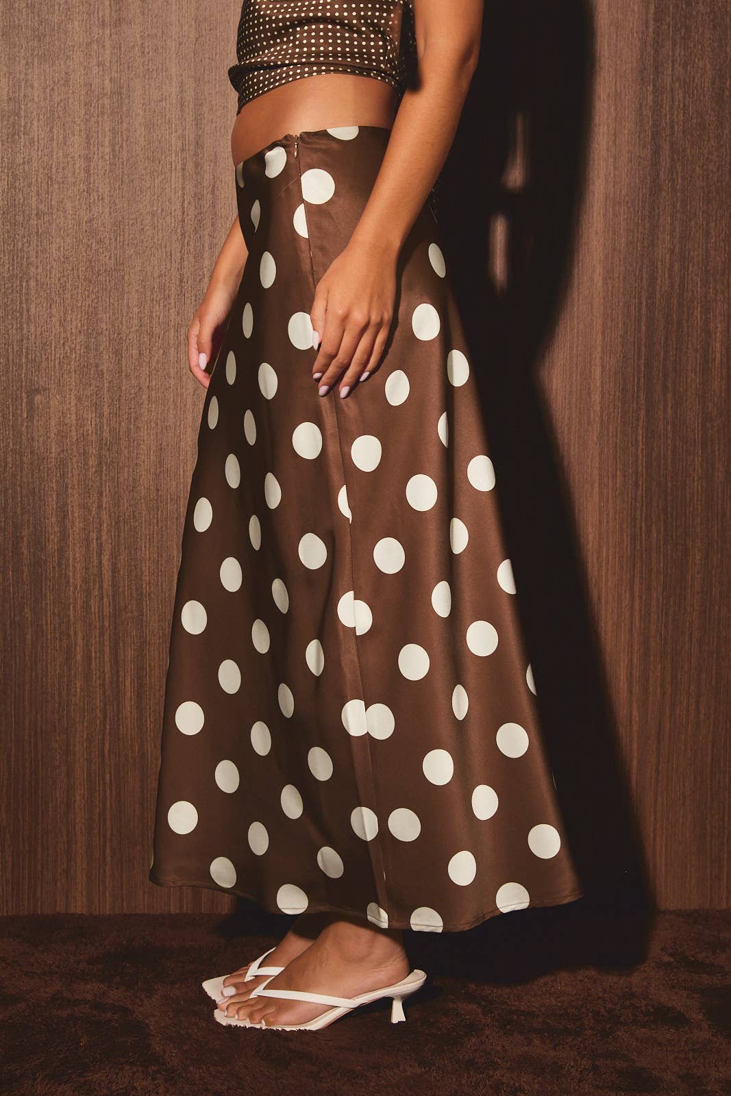 Mid-waisted polka dot bias skirt by LE LIS, showcasing a flowy design with a classic black and white polka dot pattern.