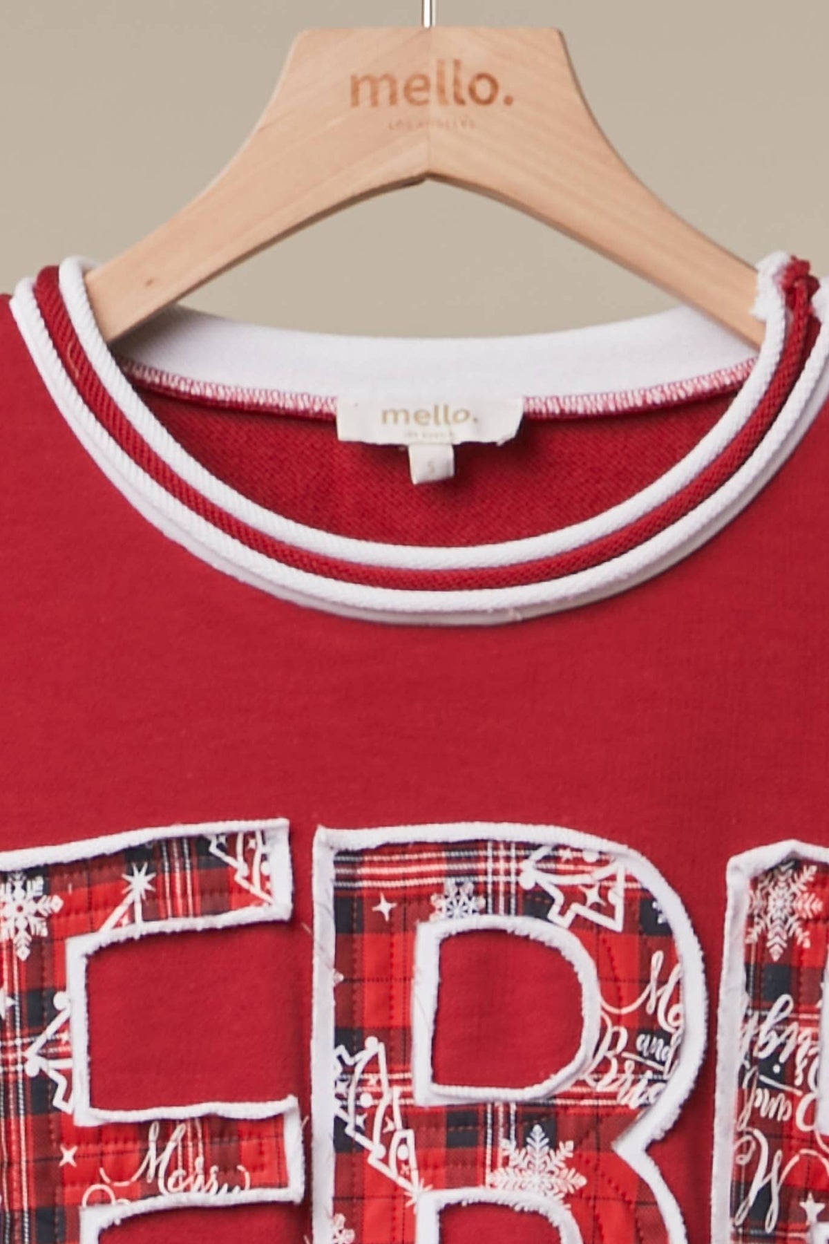 Mello Tuesday Holiday Merry Christmas letter sweatshirt featuring festive red and green design with holiday lettering and cozy fabric