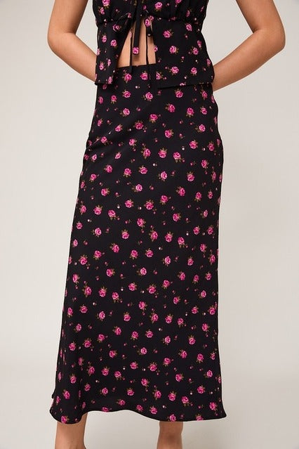 High waisted floral rose printed bias midi skirt from RARA Boutique featuring a flowy design and vibrant blossom pattern.