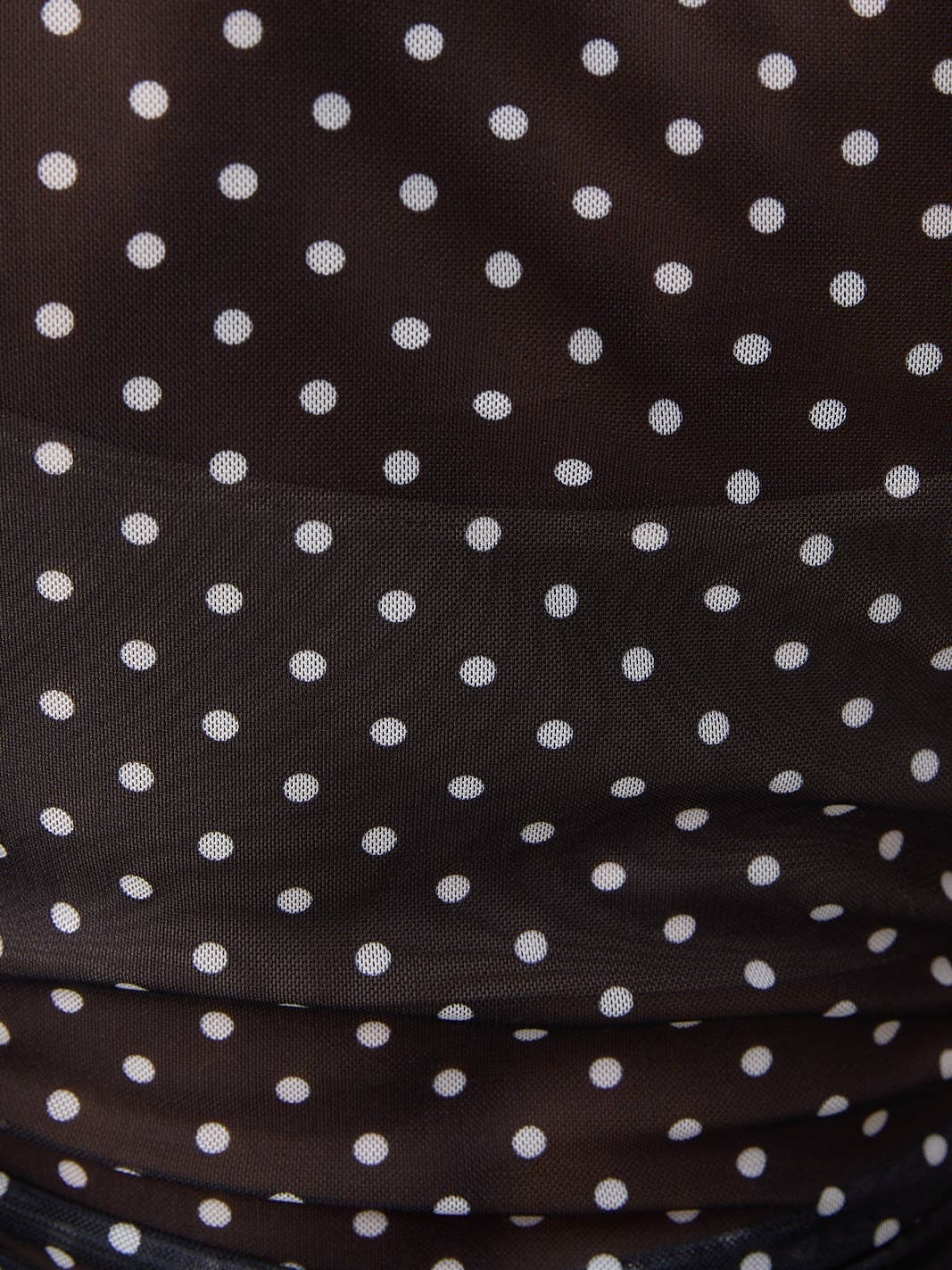 RARA Boutique polka dot mesh sleeveless blouse with mock neck, featuring a stylish and breathable design.