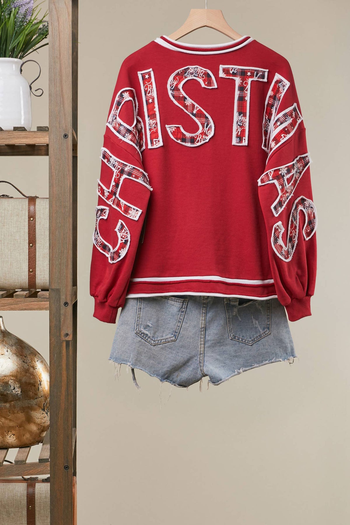 Mello Tuesday Holiday Merry Christmas letter sweatshirt featuring festive red and white design, cozy knit fabric, and holiday lettering.