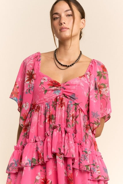 Floral tiered ruffle maxi dress with flutter sleeves from RARA Boutique, featuring a flowing design and vibrant floral pattern.