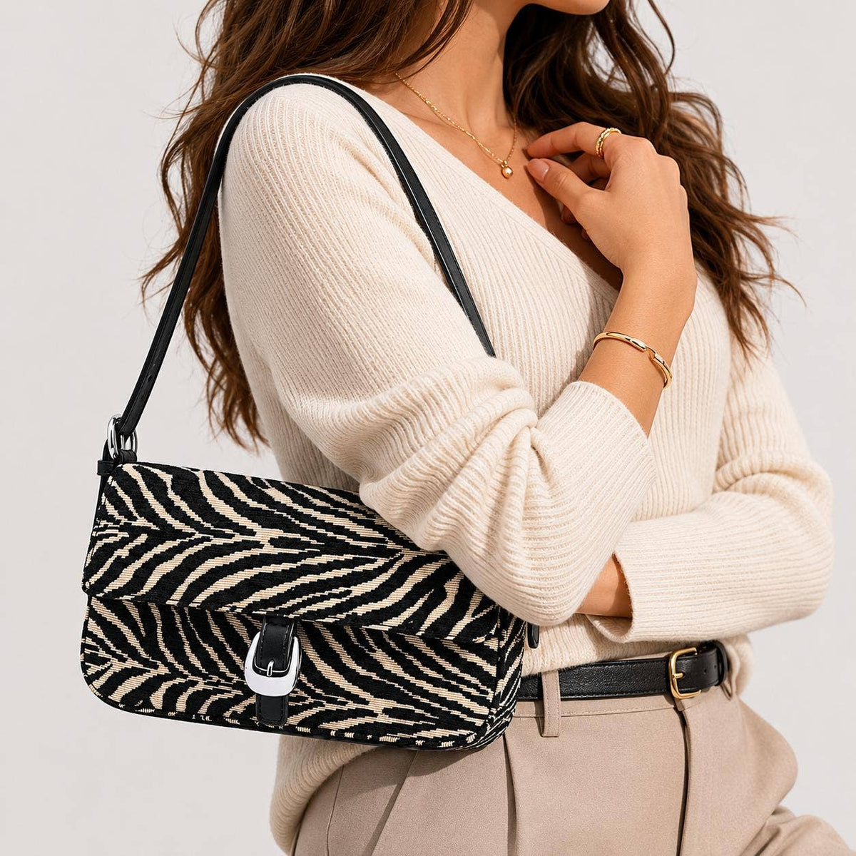 Urban Expressions Tuesday Gloria zebra shoulder bag with black strap and textured zebra print fabric.