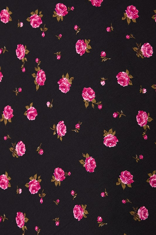 High waisted floral rose printed bias midi skirt by RARA Boutique showing a flowy, patterned skirt with a high waist and floral design.