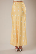 RARA Boutique polka dot satin maxi skirt with elastic waistband, flowing design and stylish pattern.