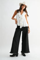 RARA Boutique studded ultra-wide leg washed jeans with distressed detailing and metal stud embellishments on light blue denim