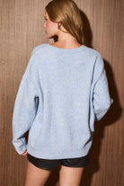 LE LIS Christmas Shop graphic long sleeve crew neck sweater with festive holiday design and cozy fit.