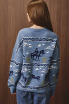 LE LIS cowboy graphic long sleeve crew neck sweater featuring a western-inspired design and comfortable knit fabric.