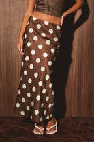 Mid-waisted polka dot bias skirt by LE LIS, featuring a flowing design with a classic pattern and feminine silhouette.