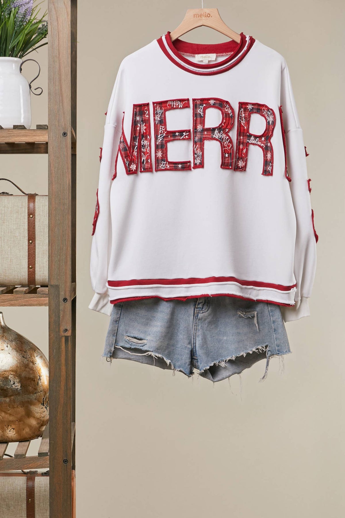 Mello Tuesday Holiday Merry Christmas letter sweatshirt featuring festive red and green design with holiday-themed lettering.