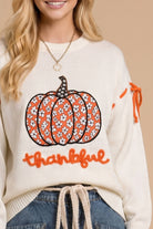 Main Strip thankful pumpkin graphic tie-sleeve sweater featuring fall-themed design and cozy knit fabric.