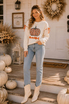 Main Strip thankful pumpkin graphic tie-sleeve sweater featuring fall-themed pumpkin design and stylish tie sleeves.