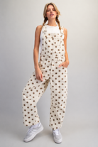 RARA Boutique polka dot barrel leg denim overalls with mineral washed finish, featuring adjustable straps and classic pocket details.