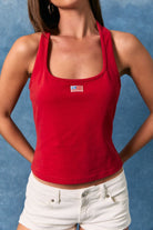 Red halter neck tank top with embroidered American flag patch from Le Lis, styled with RARA Boutique branding.