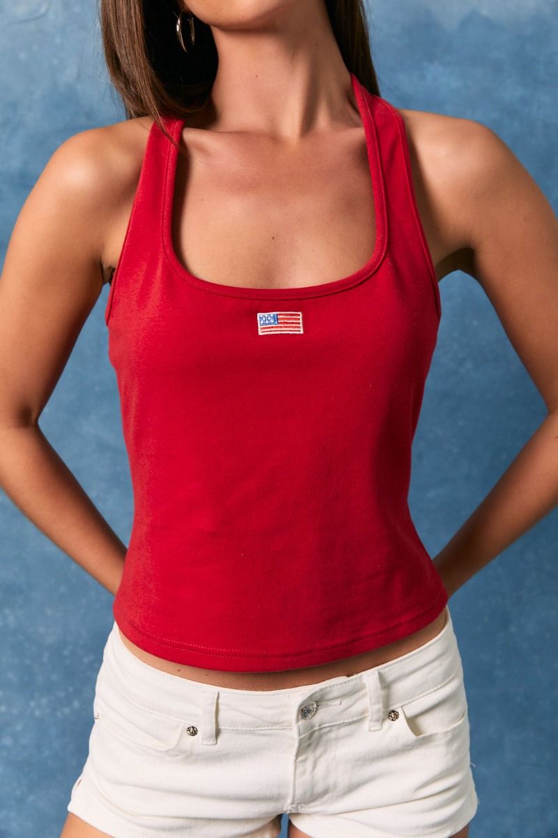 Red halter neck tank top with embroidered American flag patch from Le Lis, styled with RARA Boutique branding.