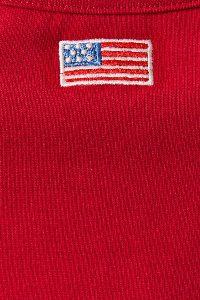 Red embroidered American flag patch halter neck tank top from RARA Boutique featuring bold flag design and stylish halter neckline.