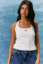 White tank top by RARA Boutique featuring a halter neck and embroidered American flag patch on the front.