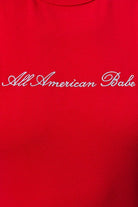 Red embroidered All American Babe tank top by Le Lis, featuring patriotic star and flag design, sleeveless casual apparel.